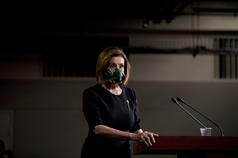 House Speaker Nancy Pelosi of Calif., wears a mask as she steps away from the podium at the conclusion of a news conference on Capitol Hill, Thursday, May 14, 2020, in Washington. (AP Photo/Andrew Harnik)


