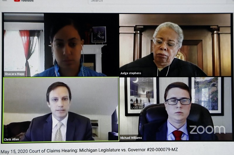 In a Friday, May 15, 2020 frame grab from video, attorney Chris Allen, lower left, of the attorney general's office presents his case before, Court of Claims Judge Cynthia Stephens, upper right, in the case Michigan House of Representatives and Michigan Senate vs. Gov. Gretchen Whitmer in Lansing, Mich. Republicans who control the Michigan Legislature are urging thejudge to strike down stay-home orders and other restrictions related to the coronavirus. They say Democratic Gov. Gretchen Whitmer has trampled their authority in determining statewide emergencies. (Carlos Osorio/Zoom via AP)


