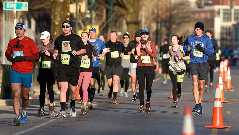 Staff Photo by Robin Rudd / Participants head east, into the rising sun, on Martin Luther King Jr. Blvd.  The 5th Erlanger Chattanooga Marathon was run on March 8, 2020.  