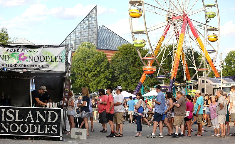 Festival-goers stand in line for food from the Island Noodles vendor booth during the third day of Riverbend Festival Friday, May 31, 2019 in Chattanooga, Tennessee. 