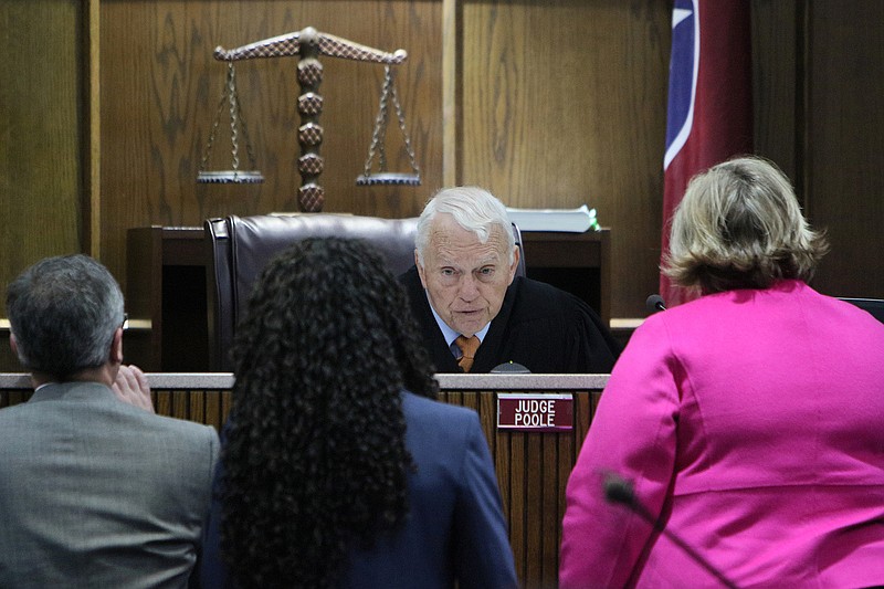 Hamilton County District Attorney General Neal Pinkston, Assistant Prosecutor Crystle Carrion and defense attorney Amanda Dunn speak with Judge Don Poole during a criminal trial Wednesday, Feb. 28, 2018 in Judge Don Poole's courtroom at the Hamilton County Courthouse in Chattanooga, Tenn. 