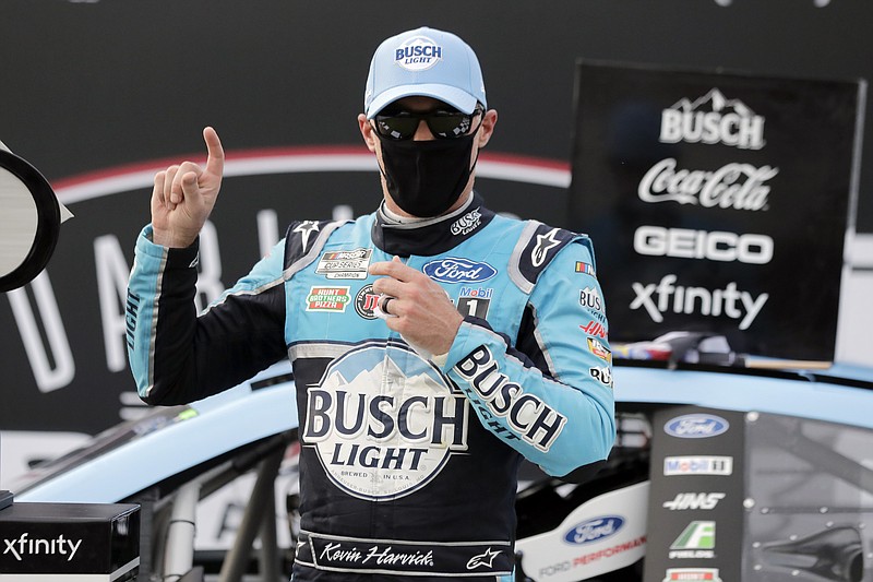 AP photo by Brynn Anderson / Kevin Harvick, wearing a mask per NASCAR guidelines amid the coronavirus pandemic, celebrates after winning Sunday's Cup Series race at Darlington Raceway in South Carolina. It was NASCAR's first race since shutting down in mid-March, and no fans were allowed inside the venue.