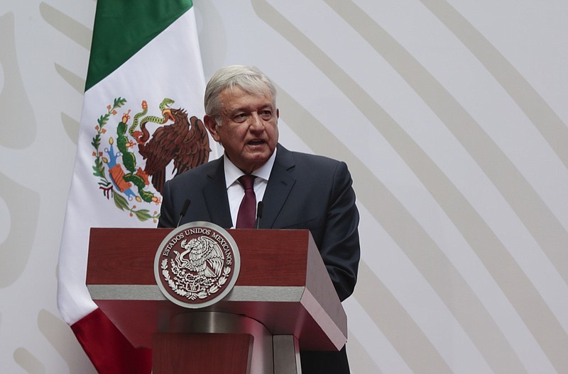 FILE - In this April 5, 2020 file photo, Mexican President Andres Manuel Lopez Obrador speaks at the National Palace in Mexico City. Over the May 17, 2020 weekend, the administration of President Lopez Obrador has cited the coronavirus pandemic as a justification for new rules that will reduce the role of renewable energies like solar and wind power, granting a reprieve to the government's own ageing, fossil-fuel power plants. (AP Photo/Eduardo Verdugo, File)