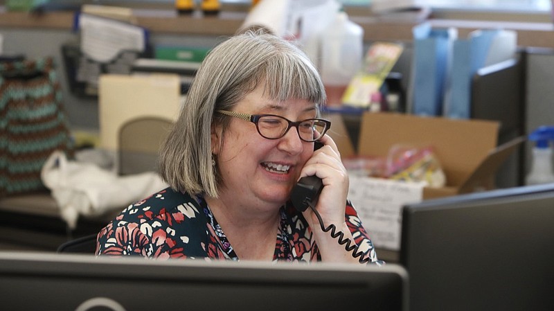 Librarian Holly Ryckman smiles as she chats with 81-year-old Dell Kaplan from the Davis Library in Plano, Texas Friday, May 15, 2020. Ryckman is participating in a program that have popped up across the U.S. during the pandemic to help older adults with a simple offer to engage in small talk. Ryckman said the calls have been "a gift" for her. (AP Photo/LM Otero)