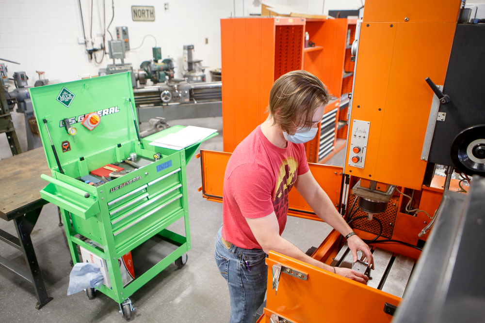 Staff photo by C.B. Schmelter / Student Chenaniah Lewis works in the Machine Tool Lab in the TCAT 2 Building on the campus of Chattanooga State Community College on Tuesday, May 19, 2020 in Chattanooga, Tenn. While most classes at the college have continued online, a few classes began instruction on campus on Monday.