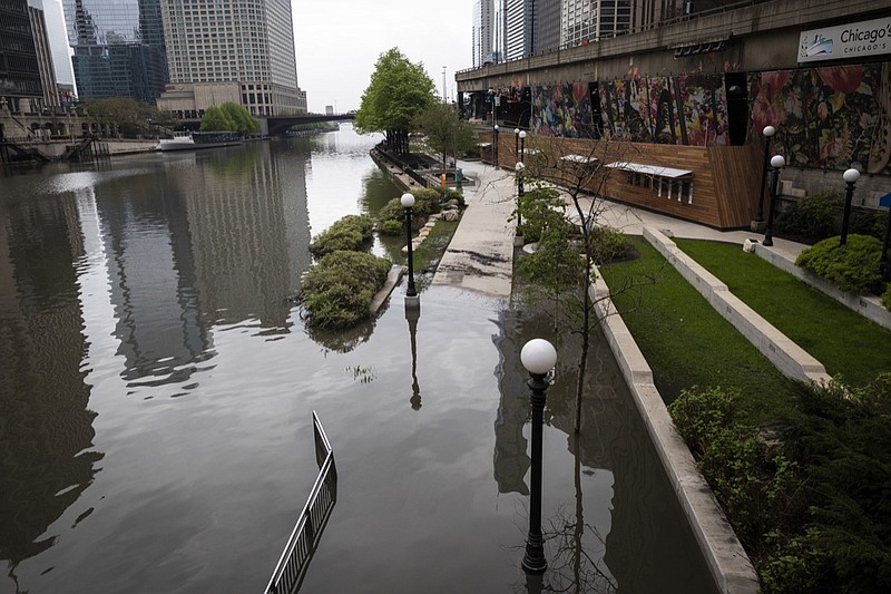 The Chicago River overflowed its banks and flooded the Riverwalk after overnight showers and thunderstorms across the city, Monday, May 18, 2020 in Chicago. (Ashlee Rezin Garcia/Chicago Sun-Times via AP)