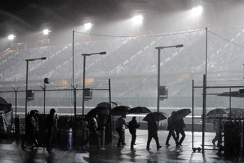 AP photo by Brynn Anderson / People leave the infield at South Carolina's Darlington Raceway after the NASCAR Xfinity Series race was postponed because of rain Tuesday night.