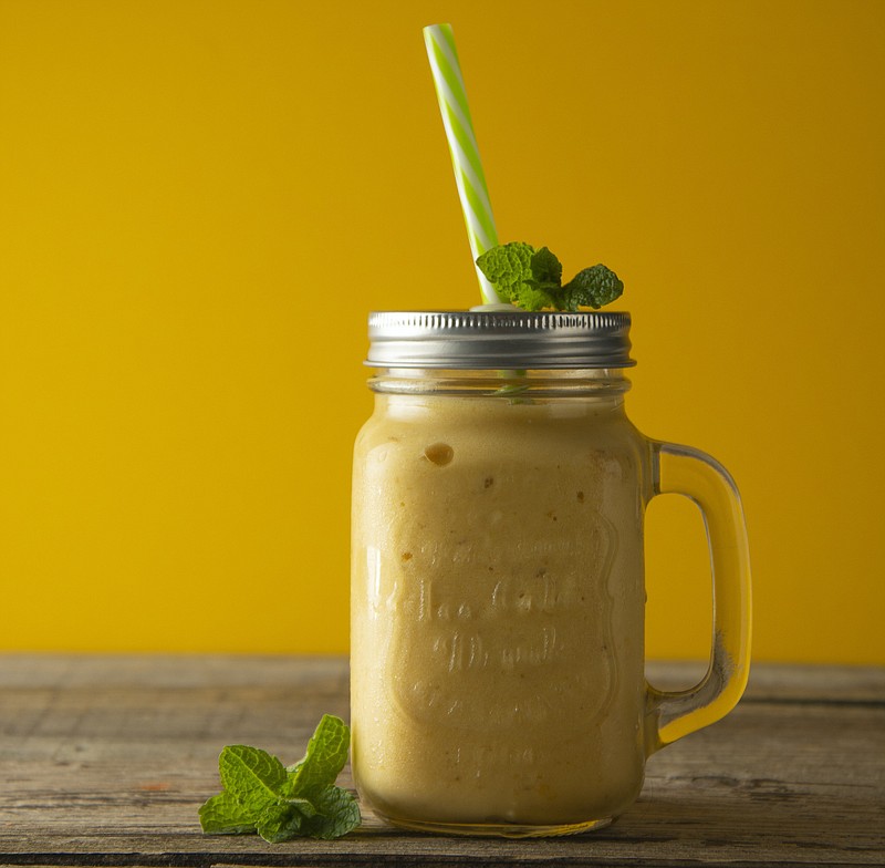 Homemade mango, lemon ice-cream or milk shake in mason jar cups, rustic wooden background. Vintage style. - stock photo ice cream tile food / Getty Images
