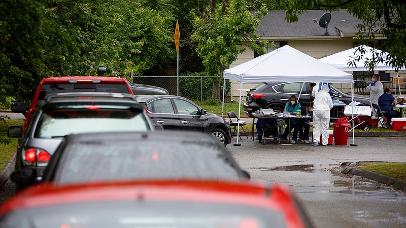 Staff photo by C.B. Schmelter / Cars wait in line to get free testing offered by Cempa Community Care at the Avondale Youth and Family Development Center on Wednesday, May 20, 2020 in Chattanooga, Tenn. Cempa was offering free walk-up and drive-thru testing for COVID-19.