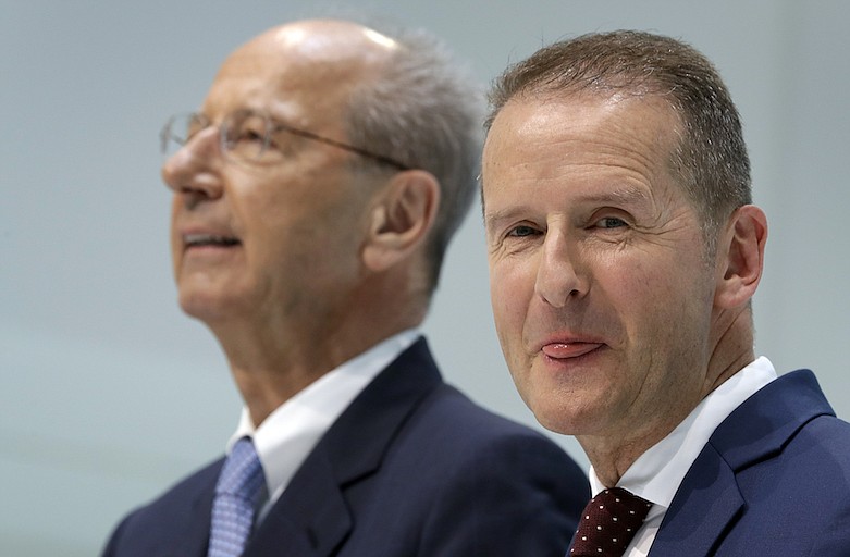 In this Friday, April 13, 2018, file photo, Herbert Diess, right, CEO of the Volkswagen, and Hans Dieter Poetsch, left, chairman of the board of directors of Volkswagen address the media during a press conference in Wolfsburg, Germany. Volkswagen said charges of securities-law violations against its CEO and board chairman are to be dropped in return for a 9 million-euro ($10 million) payment, removing a potential distraction for the company's management team as it copes with the virus crisis and oversees the rollout of a new generation of electric cars. (AP Photo/Michael Sohn, File)