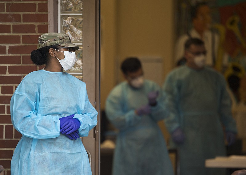 Staff photo by Troy Stolt / A member of the Tennessee National Guard Medical Staff stands outside the East Lake Courts Community Center, where free COVID-19 testing was being offered to residents of East Lake Courts on Thursday, May 21, 2020 in Chattanooga, Tenn.