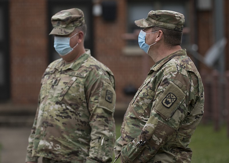 Staff photo by Troy Stolt / Members of the Tennessee National Guard stand outside the East Lake Courts Community Center where free COVID-19 testing was being offered to residents of East Lake Courts on Thursday, May 21, 2020 in Chattanooga, Tenn.