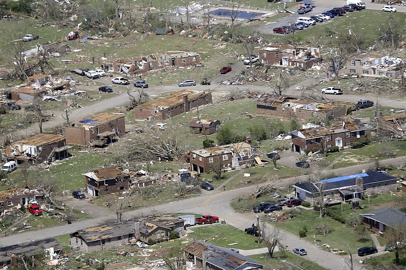 AP Photo/Mark Humphrey / Debris is scattered from damaged homes Tuesday, April 14, 2020, in Chattanooga, Tenn. The intersection in the foreground is the meeting of Holly Hills Lane, coming from the right foreground, and Holly Crest Drive. The road looping in the background is Angie Dr. The pool is the Holly Hills Community pool. Tornadoes went through the area Sunday, April 12.