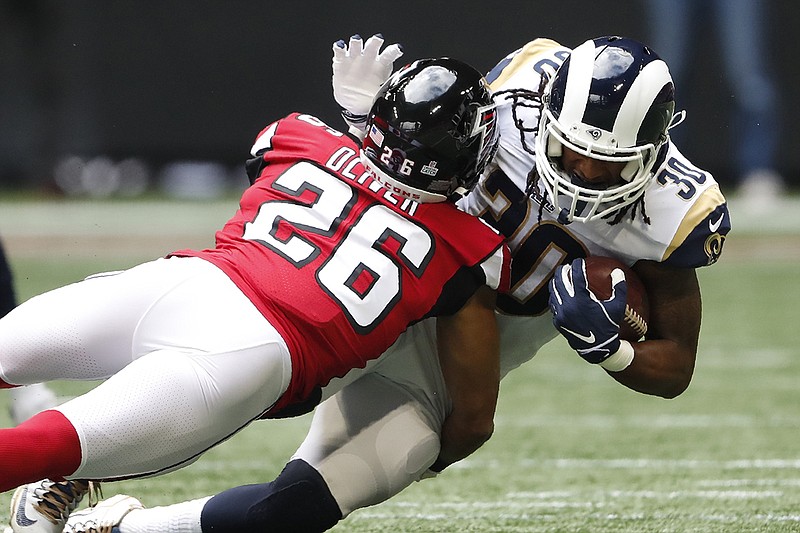 AP photo by John Bazemore / Atlanta Falcons cornerback Isaiah Oliver tackles Los Angeles Rams running back Todd Gurley on Oct. 20, 2019, in Atlanta. The two are now teammates after Gurley, a former University of Georgia star, signed with the Falcons in the offseason.