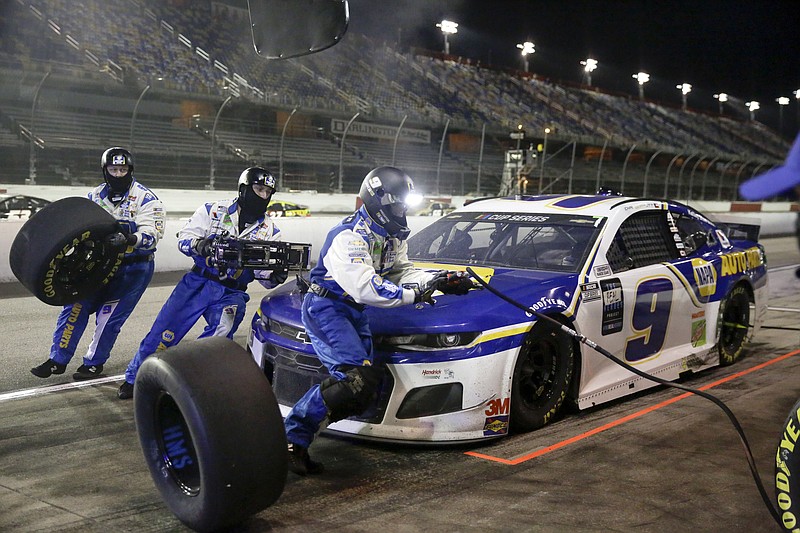 AP photo by Brynn Anderson / The Hendrick Motorsports No. 9 Chevrolet crew works during a pit stop for NASCAR Cup Series driver Chase Elliott on Wednesday in Darlington, S.C.