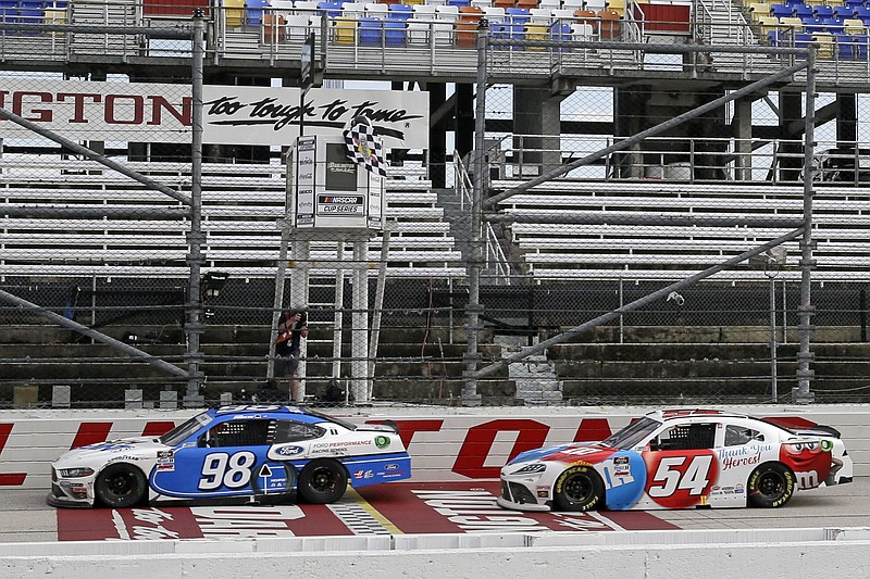 AP photo by Brynn Anderson / Chase Briscoe crosses the finish line ahead of Kyle Busch to win the NASCAR Xfinity Series race Thursday at South Carolina's Darlington Raceway.