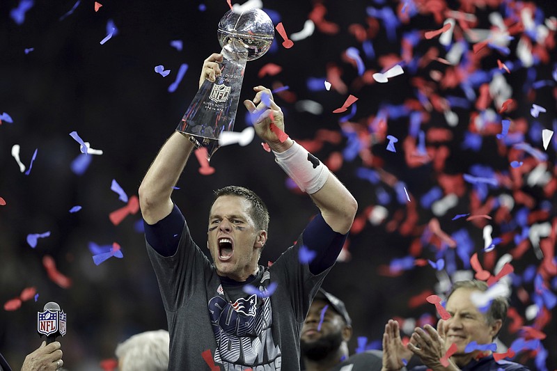 AP photo by Darron Cummings / New England Patriots quarterback Tom Brady raises the Vince Lombardi Trophy after leading his team past the Atlanta Falcons in overtime to win Super Bowl LI on Feb. 5, 2017, in Houston.