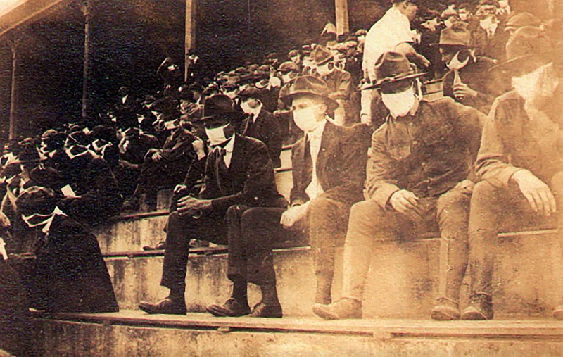 Thomas Carter photo via AP / This undated photo provided by Georgia Tech alumnus Andy McNeil shows a Georgia Tech home game during the 1918 college football season. The photo was taken by student Thomas Carter, who would receive a degree in mechanical engineering. The 102-year-old photo could provide a snapshot of sports once live games resume: Fans packed in a campus stadium in the midst of a pandemic wearing masks with a smidge of social distance between them on concrete seats.