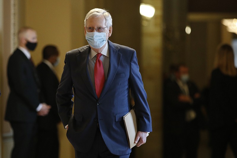 Senate Majority Leader Mitch McConnell of Ky., wears a face mask to protect against the spread of the new coronavirus as he walks to the Senate chamber after meeting with Vice President Mike Pence and Treasury Secretary Steve Mnuchin on Capitol Hill in Washington, Tuesday, May 19, 2020. (AP Photo/Patrick Semansky)


