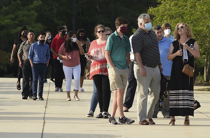 In this Wednesday, May 20, 2020 photo, friends and family members attend Spain Park High School's graduation ceremony at the Hoover Met, in Hoover, Ala. Everyone attending the ceremony had to wear a mask as a precaution against the spread of the coronavirus. (Joe Songer/The Birmingham News via AP)


