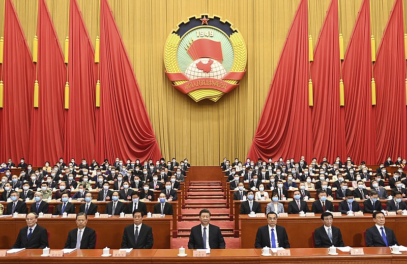 In this photo released by Xinhua News Agency, Chinese President Xi Jinping, center, attends the opening session of the Chinese People's Political Consultative Conference (CPPCC) at the Great Hall of the People in Beijing, Thursday, May 21, 2020. (Li Xueren/Xinhua via AP)


