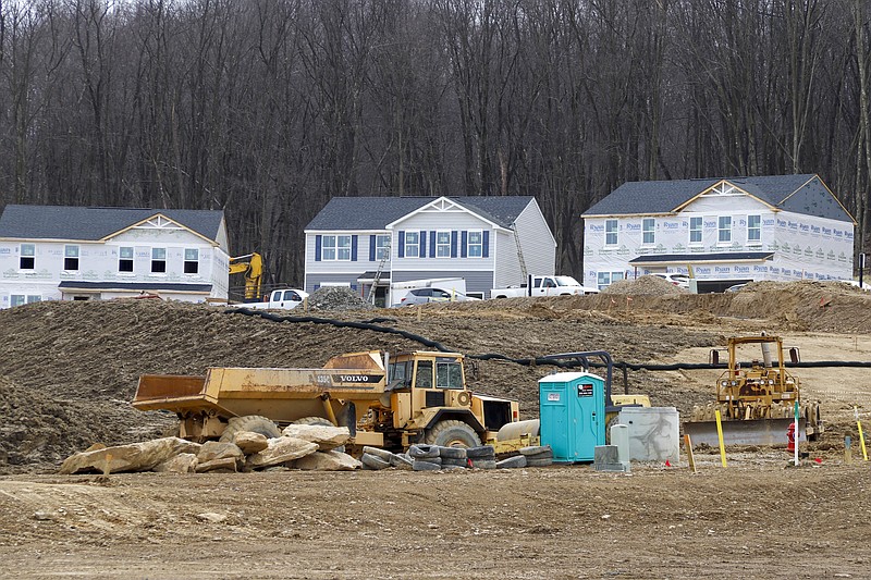 In this March 18, 2020 photo, Construction continues at a housing plan in Zelienople, Pa., The housing market has stalled, but homebuilder stocks are up sharply amid signs that sales are starting to improve. Still, the outlook for a housing market recovery remains cloudy, given uncertainty over the pandemic's impact. (AP Photo/Keith Srakocic)


