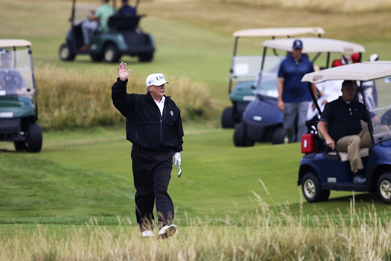File photo by Peter Morrison of The Associated Press / U.S. President Donald Trump waves while playing golf at Turnberry golf club, Scotland, on July 14, 2018.