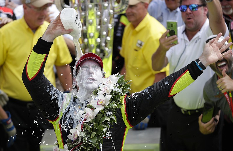 AP photo by Michael Conroy / Team Penske driver Simon Pagenaud douses himself in milk in the classic Indianapolis 500 winner's celebration on May 26, 2019. This year's Indy 500 has been moved from its traditional Memorial Day weekend date to August because of the coronavirus pandemic.