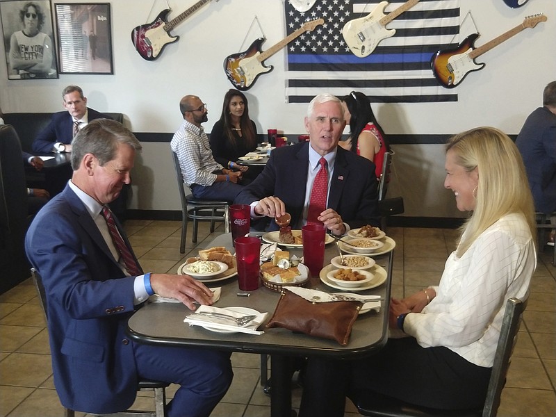 Vice President Mike Pence eats lunch with Georgia Gov. Brian Kemp and his wife Marty Kemp at the Star Cafe, Friday, May 22, 2020, in Atlanta. Pence said Georgia was "leading the way" and the country was making progress against the coronavirus. (Rob Crilly/The Washington Examiner via AP, Pool)