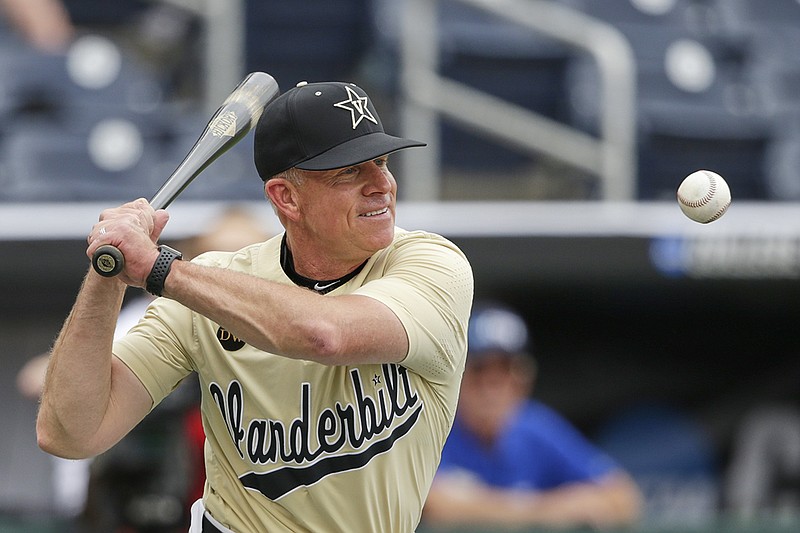 AP photo by Nati Harnik / Vanderbilt baseball coach Tim Corbin hits ground balls during practice on June 14, 2019, at TD Ameritrade Park in Omaha, Neb., before the Commodores faced Louisville in the opening round of the College World Series. Vanderbilt advanced to the title series against Michigan, losing the opener before winning the next two games to earn the progam's second national championship.