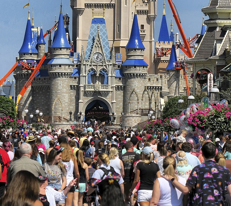 AP file photo by Joe Burbank / A crowd fills Main Street USA in front of Cinderella Castle in the Magic Kingdom at Walt Disney World near Orlando, Florida.