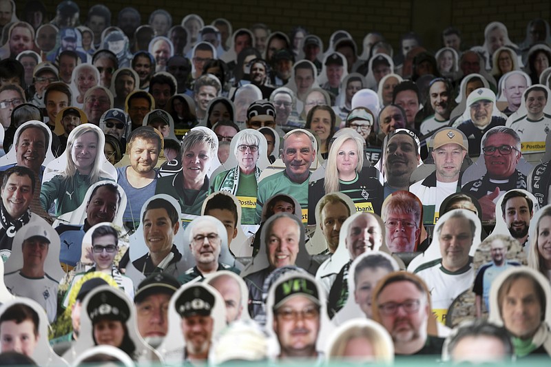 AP photo by Ina Fassbender / Cardboard pictures of fans are in their seats for a German soccer league match between host Borussia Moenchengladbach and Bayer Leverkusen on Saturday.