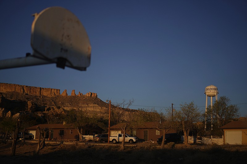 AP photo by Carolyn Kaster / A basketball backboard is seen in the foreground as the sun rises April 19 on the water tower and the school in Chilchinbeto, Ariz., on the Navajo Nation reservation. Basketball is woven in the fabric of Native American life, with the tie dating back to the earliest days of the sport.