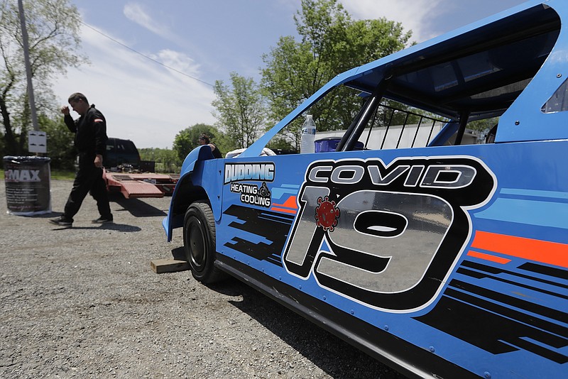 AP photo by Darron Cummings / Gabe Wilkins walks away from his car at Gas City I-69 Speedway on sunday in Gas City, Ind.