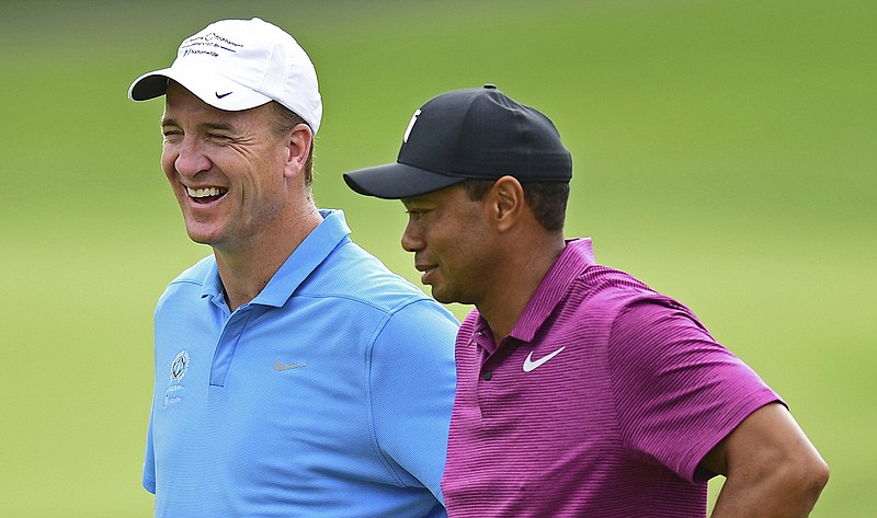 AP photo by David Dermer / Former University of Tennessee and NFL quarterback Peyton Manning, left, laughs while talking with Tiger Woods on the 11th hole at Muirfield Village Golf Club during the pro-am for the Memorial Tournament on May 30, 2018, in Dublin, Ohio.