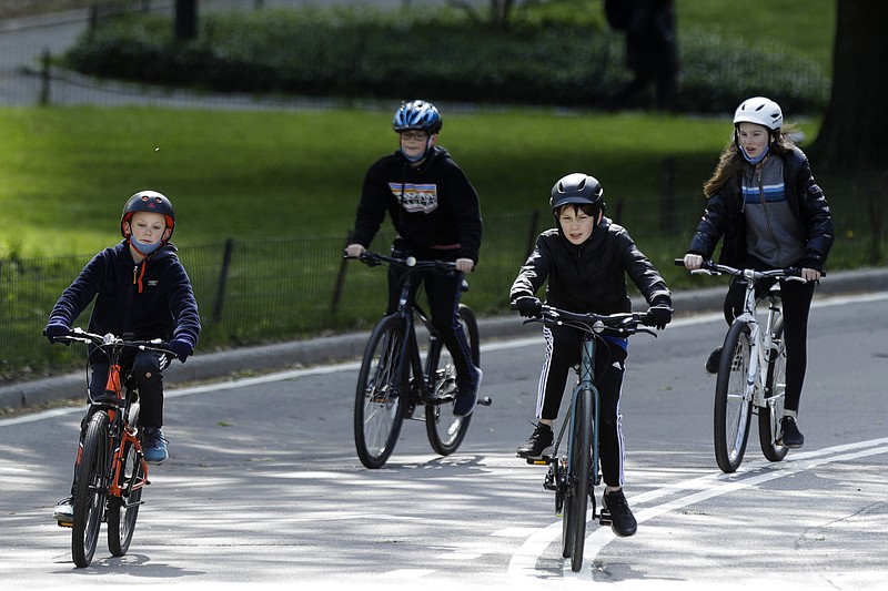 AP photo by Frank Franklin II /Y oungsters ride bicycles through New York's Central Park on May 9.