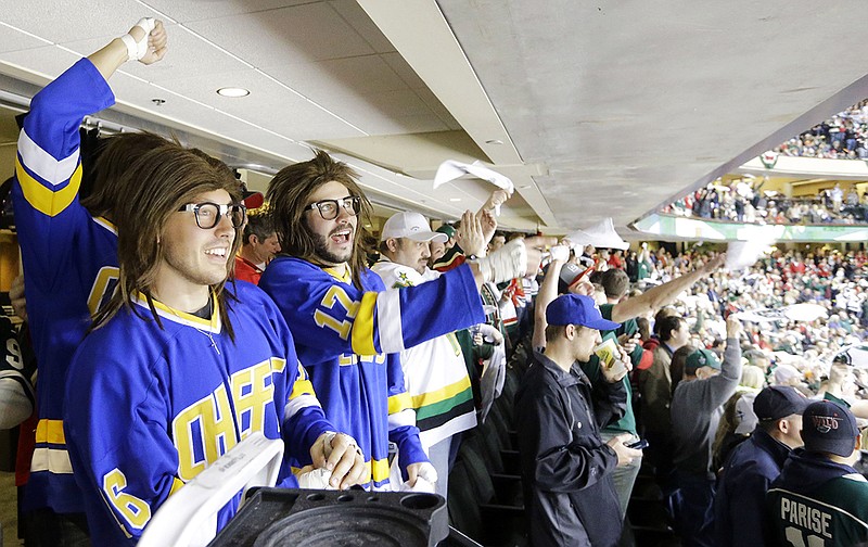 AP photo by Ann Heisenfelt / Fans dressed as the Hanson Brothers from the movie "Slap Shot" cheer during a playoff game between the Chicago Blackhawks and the host Minnesota Wild in May 2014.
