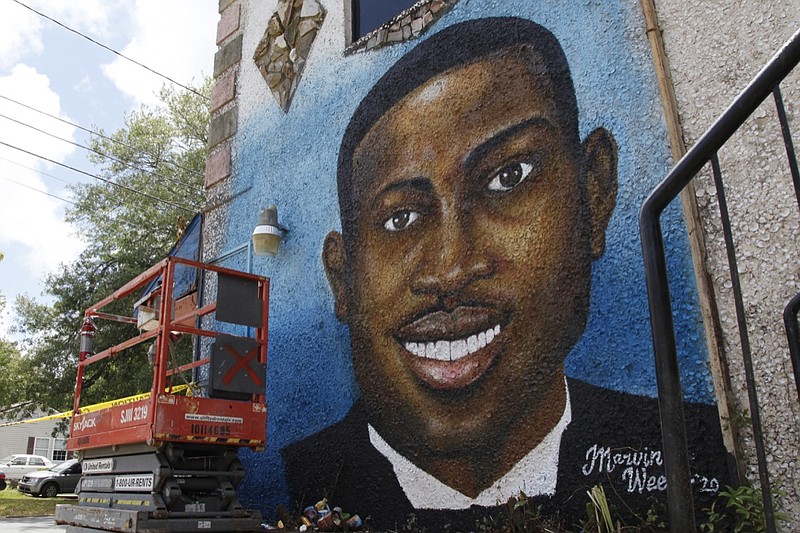 In this May 17, 2020, photo, a recently painted mural of Ahmaud Arbery is on display in Brunswick, Ga., where the 25-year-old man was shot and killed in February. It was painted by Miami artist Marvin Weeks. (AP Photo/Sarah Blake Morgan)