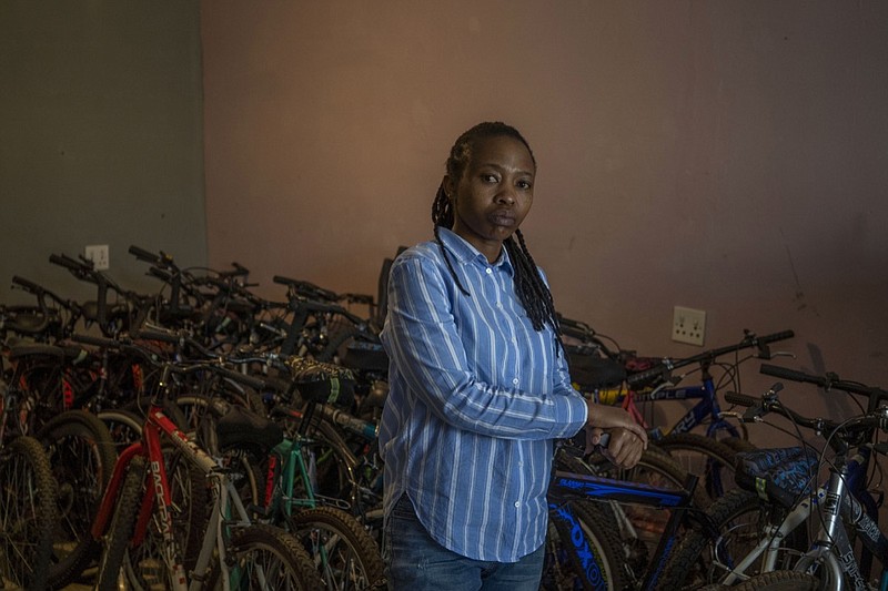 In this Friday May 1, 2020 photo, 34-year-old entrepreneur Fino Dlamini poses for a photograph inside her office in the Soweto township outside Johannesburg, South Africa. Business was good in January and February, and projections for the rest of 2020 were excellent. Then the coronavirus brought everything to an abrupt halt. Dlamini was confined to her small home under a strict lockdown, with few options for earning money. South Africa is struggling to balance its fight against the coronavirus with its dire need to resume economic activity. The country with the Africa's most developed economy also has its highest number of infections — more than 19,000. (AP Photo/Bram Janssen)