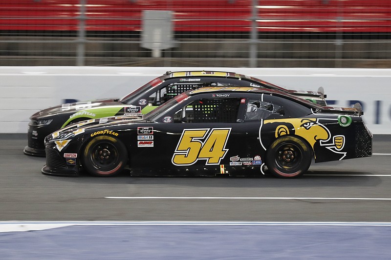 AP photo by Gerry Broome / Kyle Busch (54) and Ross Chastain battle during Monday night's NASCAR Xfinity Series race at Charlotte Motor Speedway in Concord, N.C.