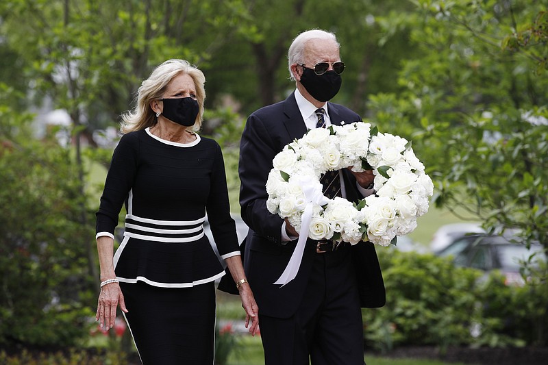 Masked Democratic presidential candidate Joe Biden, accompanied by his wife Jill, arrive to lay a wreath at the Delaware Memorial Bridge Veterans Memorial Park on Monday in New Castle, Delaware.