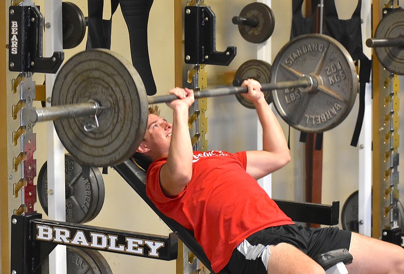 Staff photo by Patrick MacCoon / Bradley Central senior Braydon Clark works on his incline bench press during Wednesday's practice.