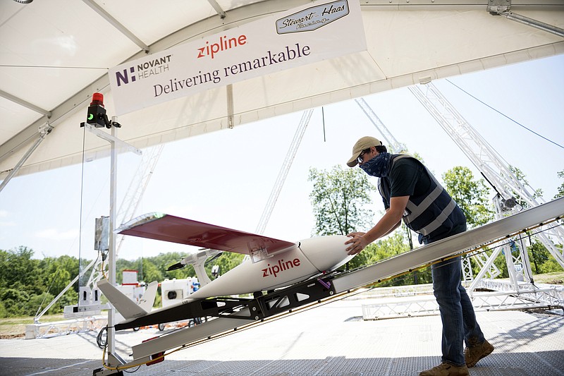 In this undated image provided by Novant Health, a preflight check is done on drone before a delivery from Novant Health Logistics Center in Kannapolis, N.C., to Novant Health Medical Center in Huntersville, N.C. North Carolina is a testing ground for drone programs involving medical supplies, and this week one of the first deliveries of personal protective equipment in the U.S. was dropped at a hospital by drone. The drones carry up to 4 pounds, and have a round-trip range of 100 miles. (Davis Turner/Novant Health via AP)


