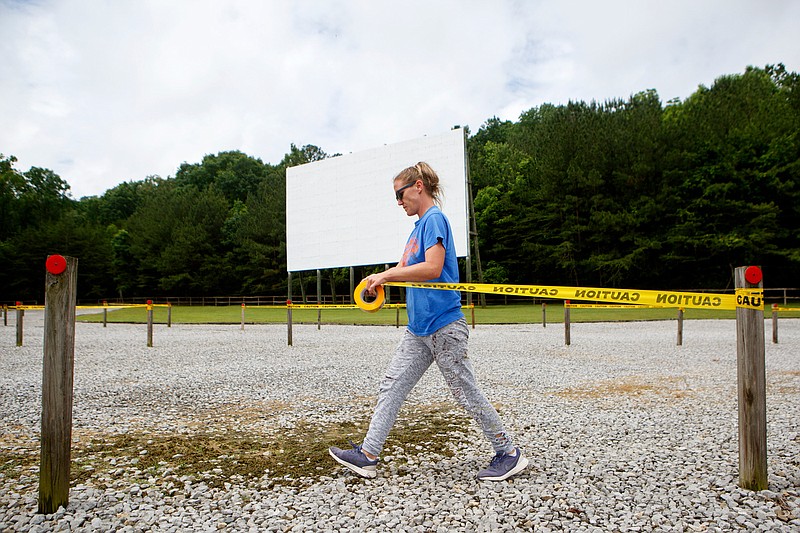Staff photo by C.B. Schmelter / Alicia Ford blocks off every other parking spot at Wilderness Outdoor Movie Theater in Trenton, Ga.