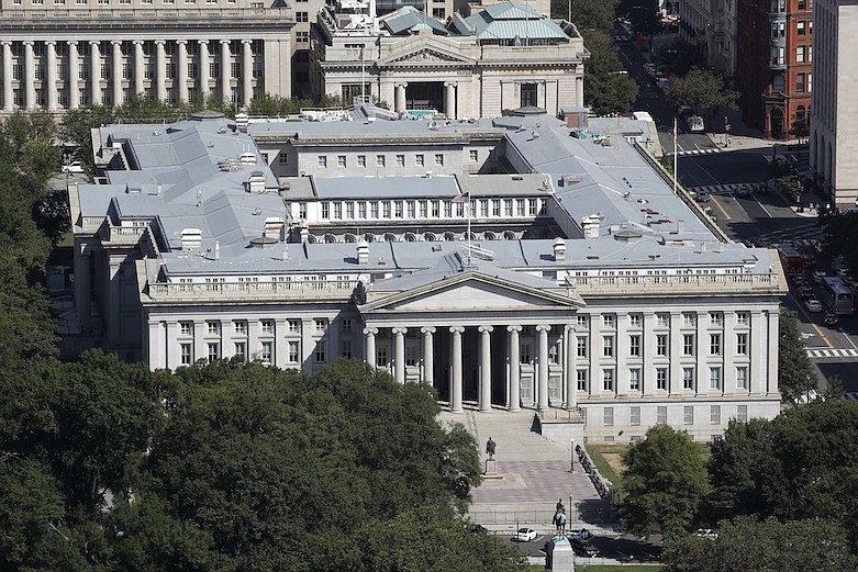 This Sept. 18, 2019 photo shows the U.S. Treasury Department building viewed from the Washington Monument in Washington. The Treasury Department says it will need to borrow a record $2.99 trillion during the current April-June quarter to cover the cost of various rescue efforts dealing with the coronavirus pandemic. Treasury said Monday, May 4, 2020 that the $2.99 trillion it plans to borrow this quarter will far surpass the $530 billion quarterly borrowing it did in the July-September 2008 quarter as it dealt with the 2008 financial crisis. The extraordinary sum of $2.99 trillion of borrowing in a single quarter dwarfs the $1.28 trillion the government borrowed in the bond market for all of 2019. (AP Photo/Patrick Semansky)