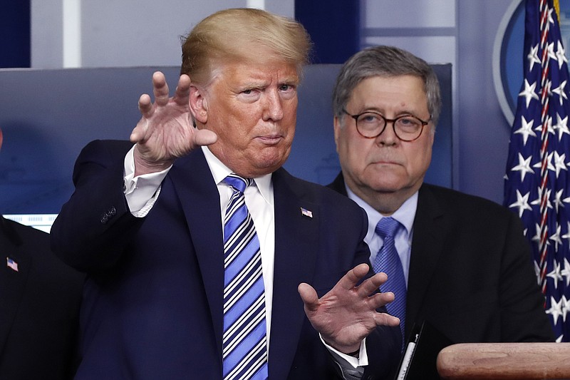 FILE- In this March 23, 2020 file photo, President Donald Trump talks during a briefing about the coronavirus in the James Brady Briefing Room, Monday, March 23, 2020, in Washington, as Attorney General William Barr looks on. Legislation to extend surveillance authorities that the FBI sees as vital in fighting terrorism was thrown in doubt Wednesday as President Donald Trump, the Justice Department and congressional Republicans all came out in opposition. (AP Photo/Alex Brandon)


