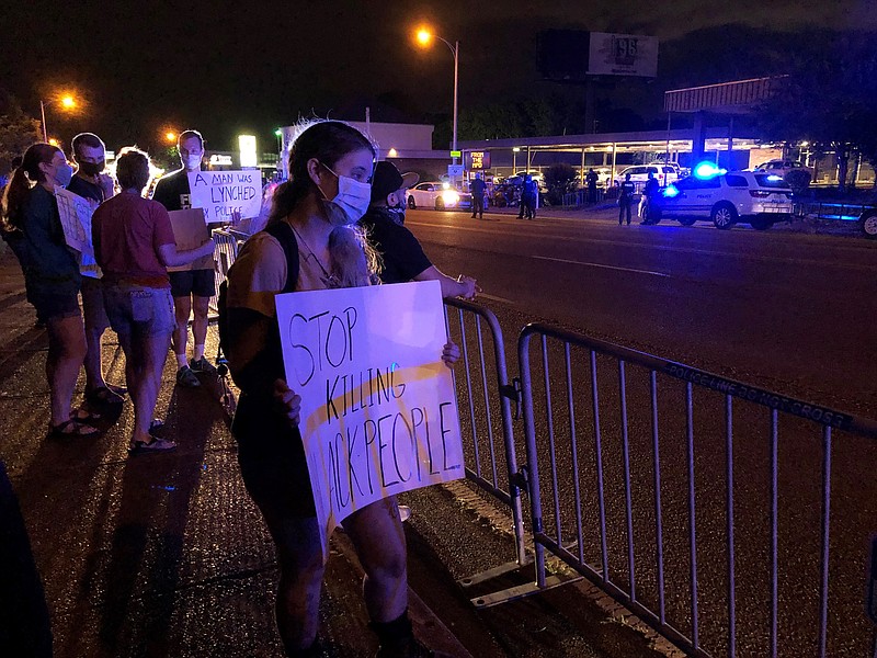 Protesters in Memphis, Tenn.. gather outside a police precinct Wednesday, May 27, 2020, to voice their anger of the death of George Floyd in police custody in Minneapolis. George Floyd died Monday after a white police officer kneeled against his neck for several minutes. (AP Photo/Adrian Sainz)
