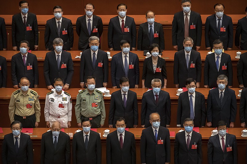 Delegates stand during the closing session of China's National People's Congress (NPC) in Beijing, Thursday, May 28, 2020. China's ceremonial legislature has endorsed a national security law for Hong Kong that has strained relations with the United States and Britain. (AP Photo/Mark Schiefelbein)