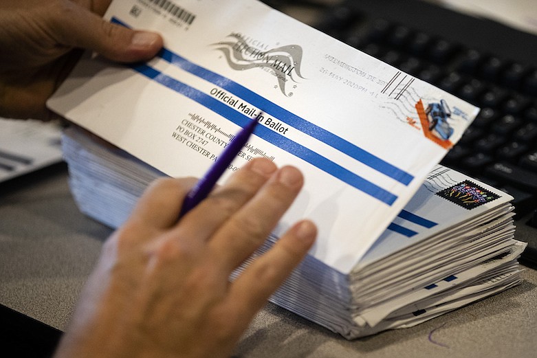 Dave Turnier processes mail-in ballots at at the Chester County Voter Services office in West Chester, Pa., prior to the primary election, Thursday, May 28, 2020. (AP Photo/Matt Rourke)