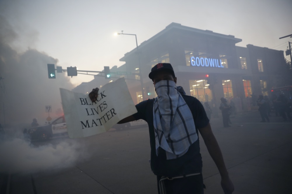 A demonstrator displays a "Black Lives Matter" sign Thursday, May 28, 2020, in St. Paul, Minn. Protests over the death of George Floyd, a black man who died in police custody, broke out in Minneapolis for a third straight night. (AP Photo/John Minchillo)
